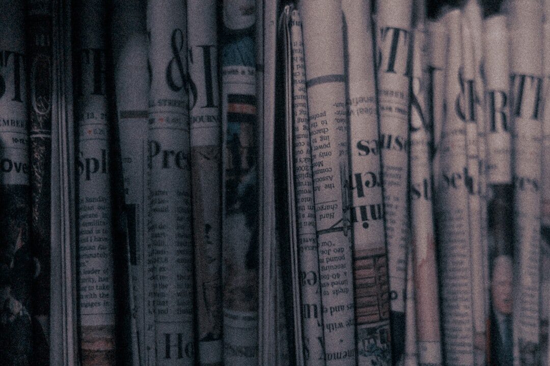 Close-up of printed newspaper pages spread on a table