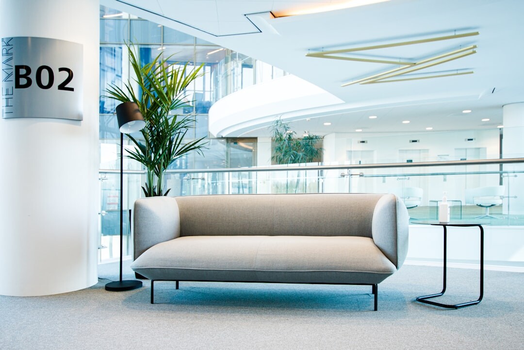 Modern bright office interior with open workspace and large windows